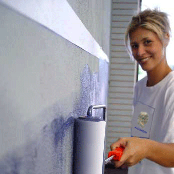 image of lady painting an interior of house